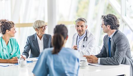 Image if happy doctors and business professionals talking