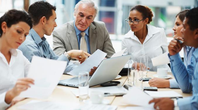 Image of colleagues in a business meeting around a table