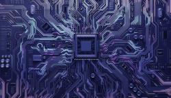 Image of a circuit board with a chip in the middle. 