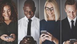 Image of a smiling group of diverse businesspeople on mobile devices.